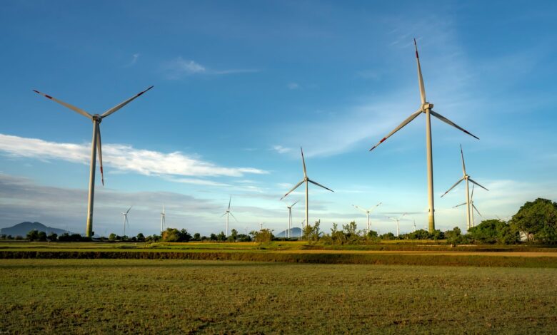 Wind turbines operating across a flat agricultural field representing wind energy infrastructure