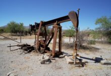 Oil well equipment in an open field representing oilfield infrastructure investment