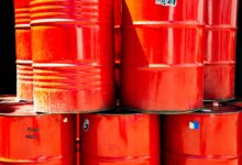 Large industrial chemical storage tanks at a port terminal facility