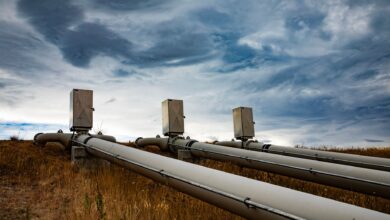 Large industrial pipeline stretching across open land representing energy transport infrastructure