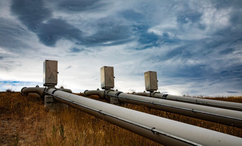 Large industrial pipeline stretching across open land representing energy transport infrastructure