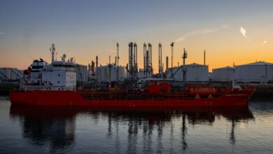 Large crude oil tanker docked at an industrial port terminal