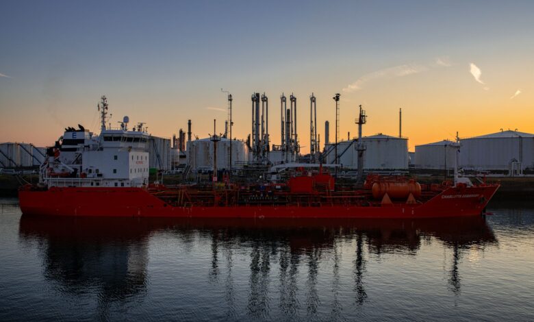 Large crude oil tanker docked at an industrial port terminal