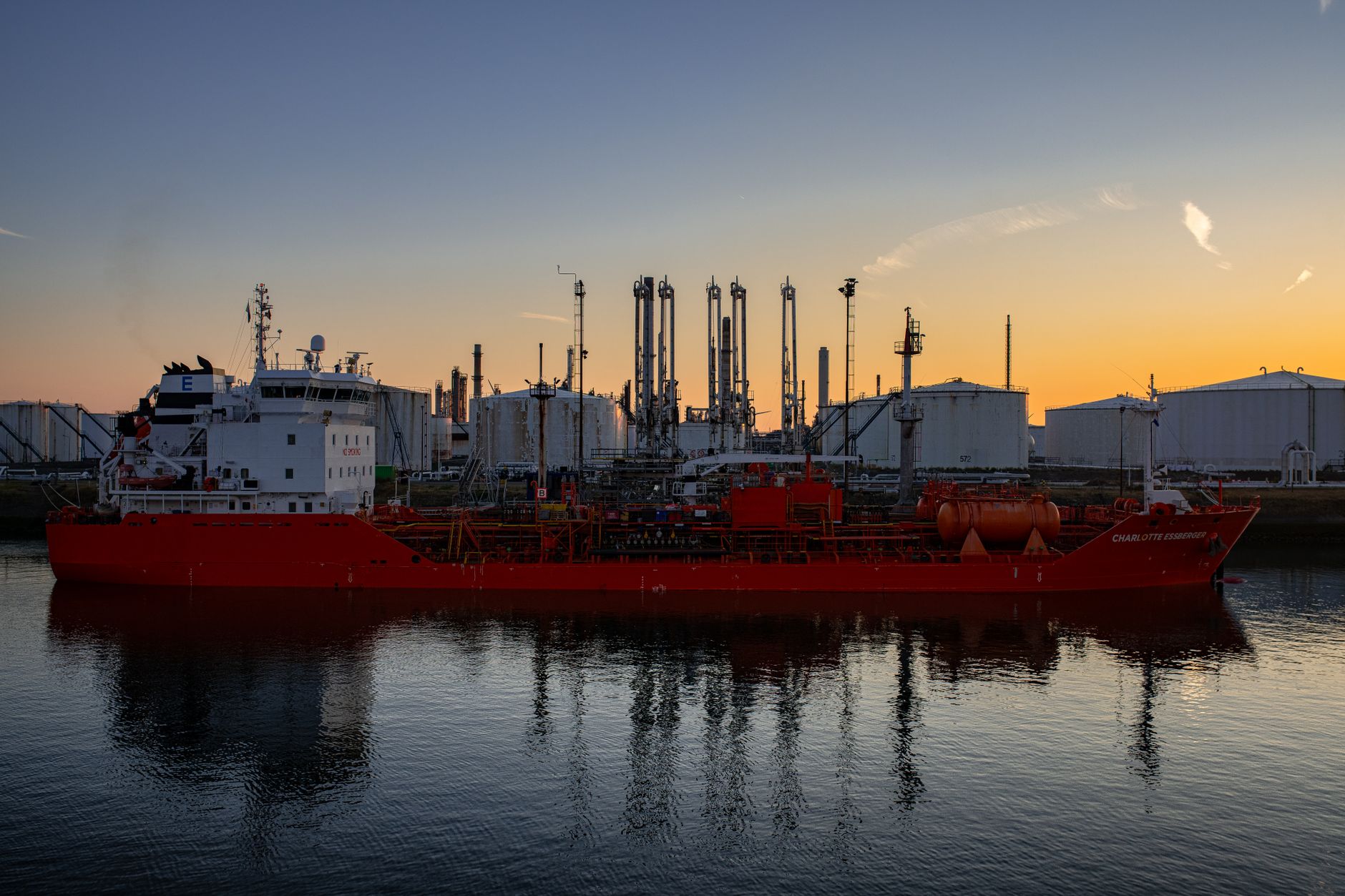 Large crude oil tanker docked at an industrial port terminal