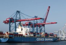 Large industrial port terminal with storage tanks and shipping infrastructure