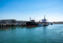Large LNG regasification terminal at a coastal industrial port facility