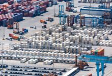 Aerial view of a deepwater container port with large cargo vessels docked at terminal berths