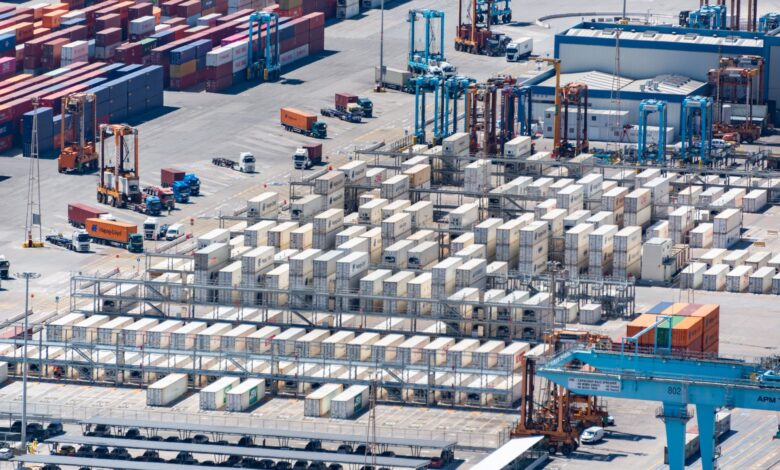 Aerial view of a deepwater container port with large cargo vessels docked at terminal berths