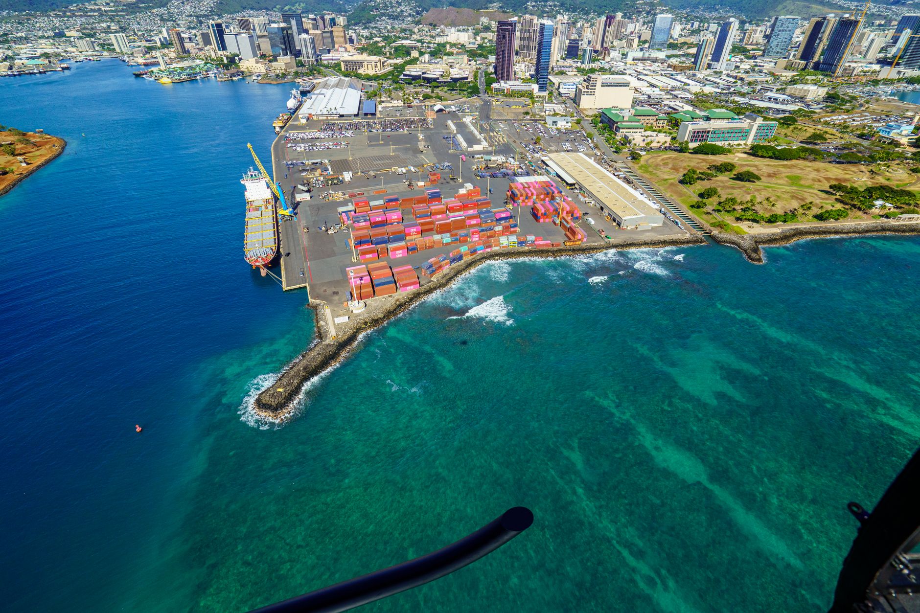 Aerial view of a major commercial cargo port with docked vessels