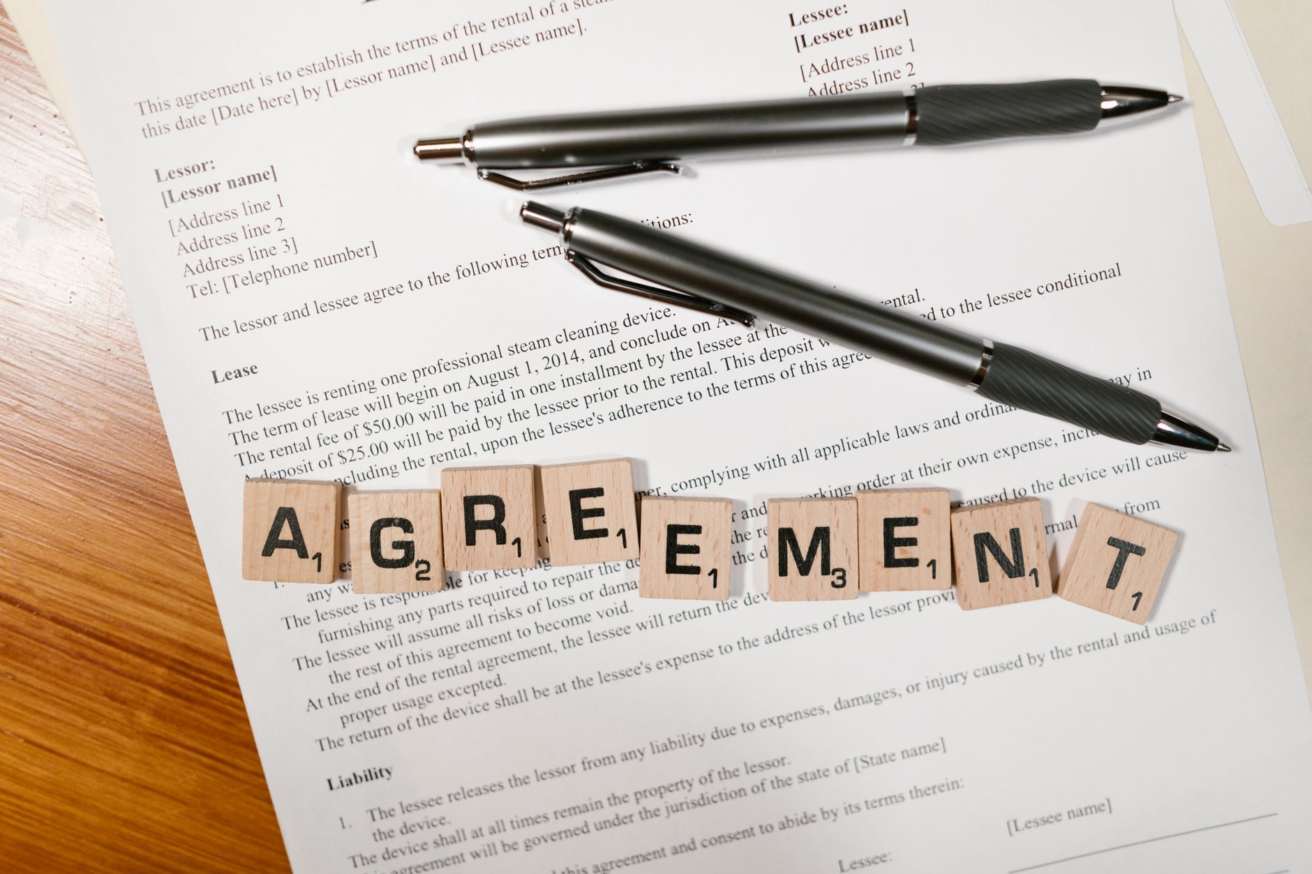 Legal documents and contracts spread across a desk representing land lease agreements