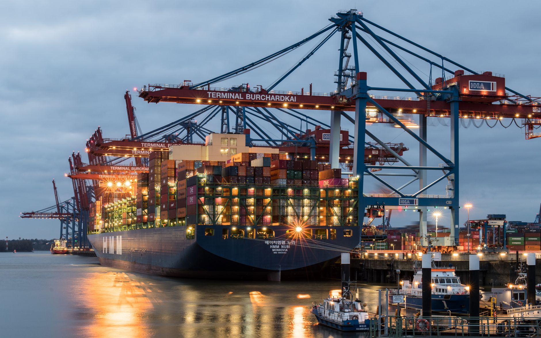 Aerial view of a busy cargo and oil terminal with docked vessels