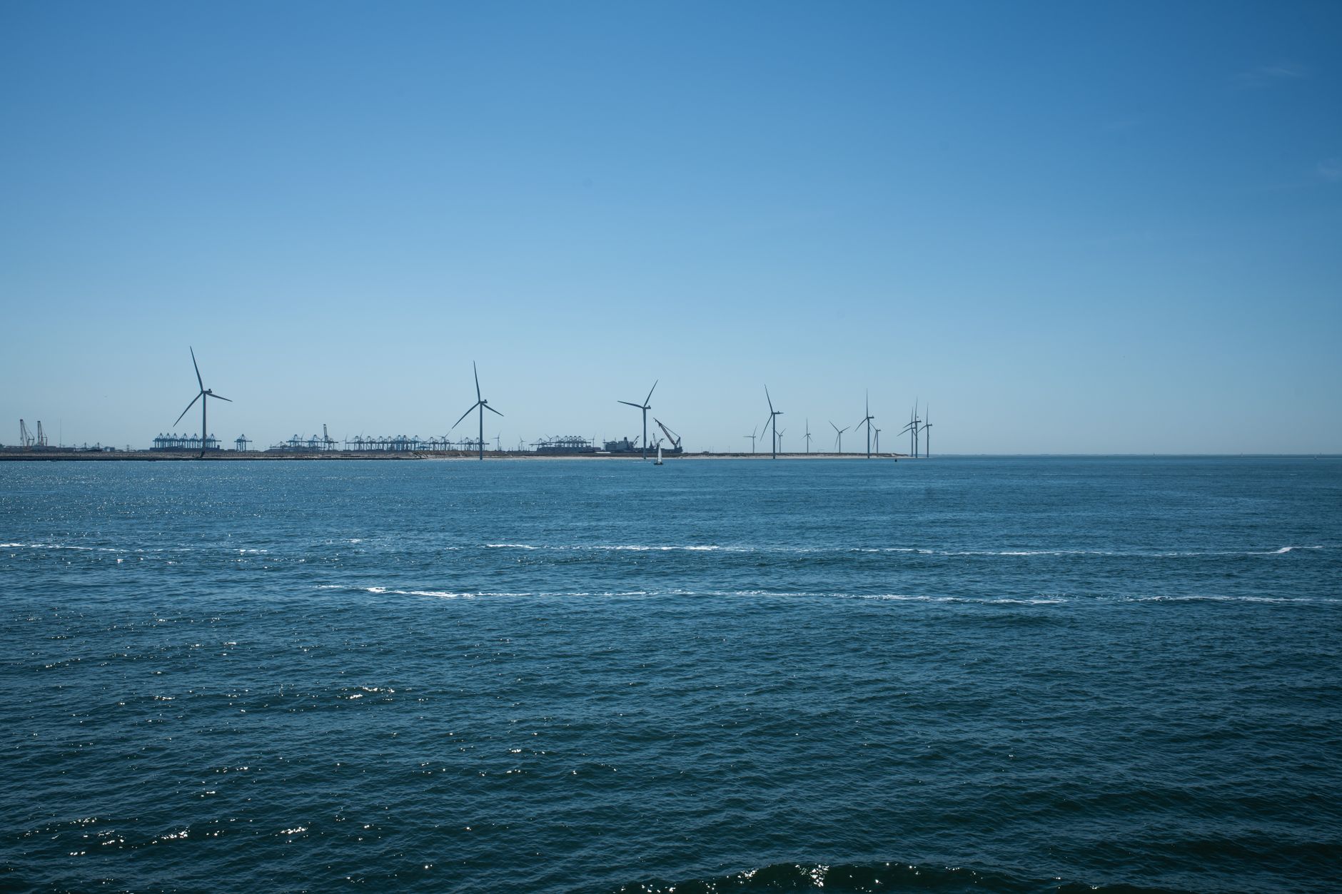 Offshore wind turbines at sea connected by subsea power cables to onshore grids