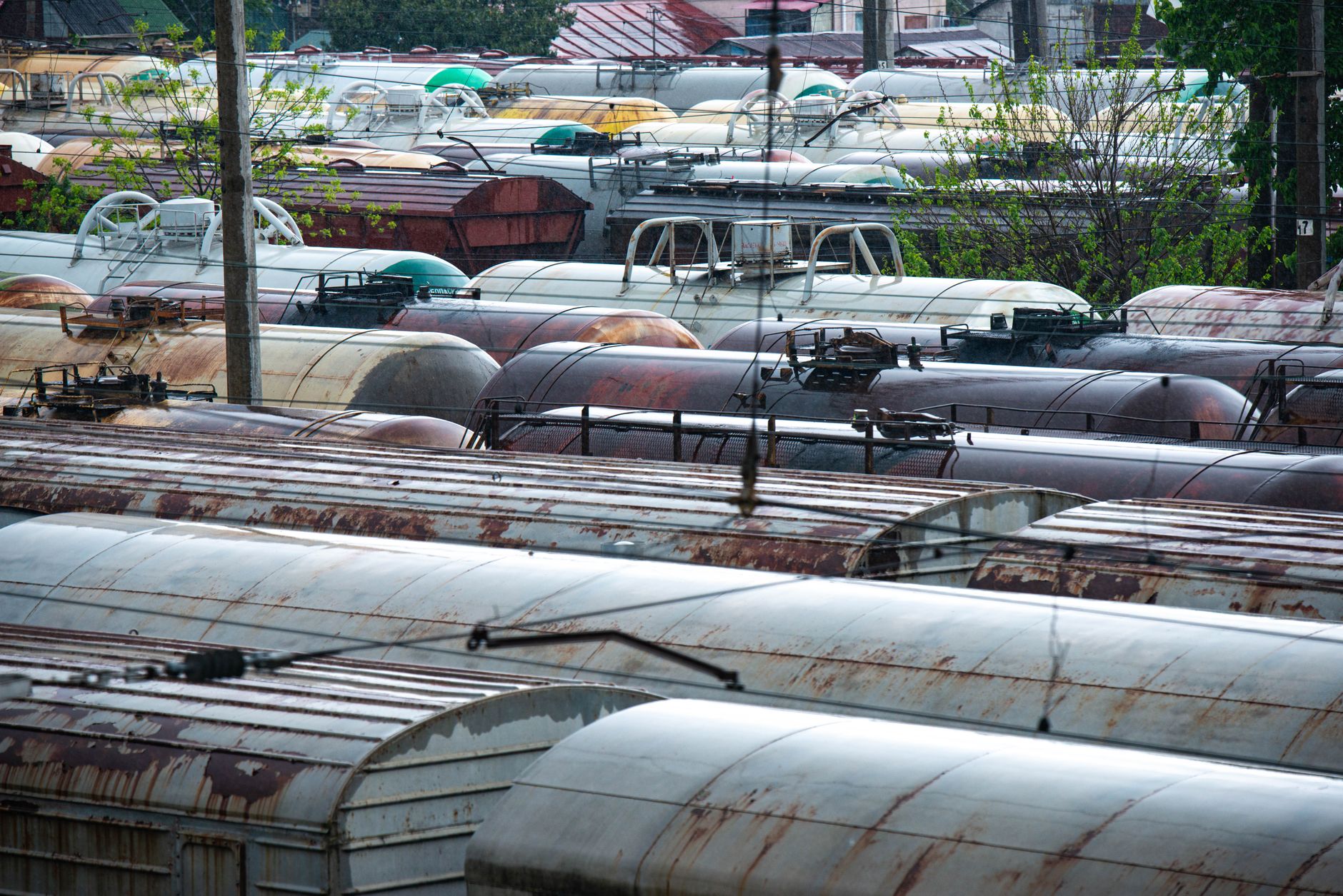 Aerial view of an industrial rail yard with freight cars and loading facilities