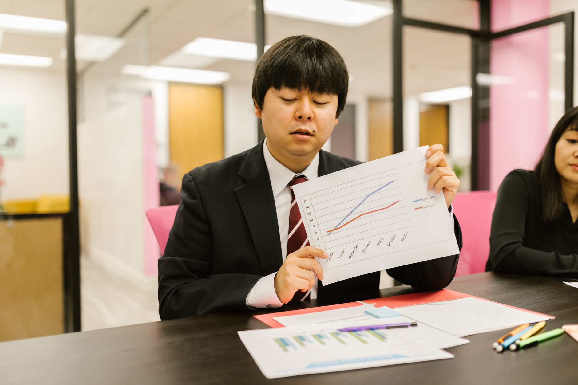 Institutional investors reviewing alternative asset allocation documents at a conference table
