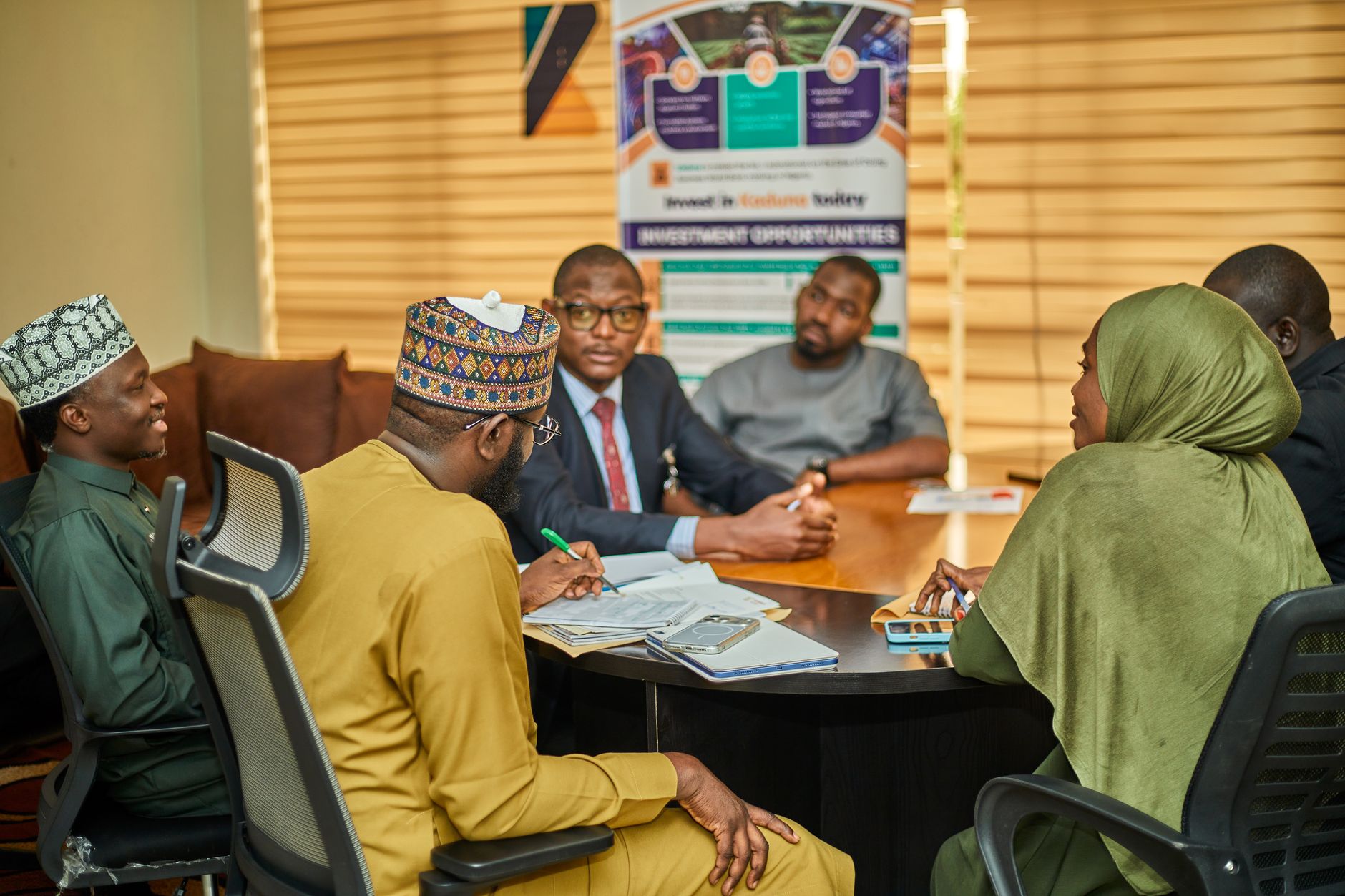 Professionals reviewing investment documents at a private meeting table