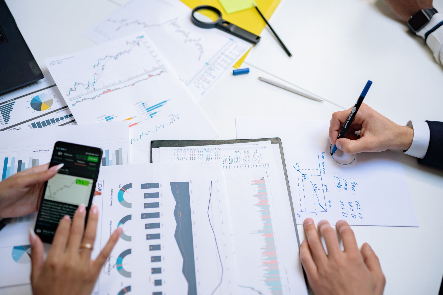 Business professionals reviewing investment documents at a conference table
