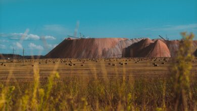 Open-pit bauxite mine with heavy excavation equipment and exposed red ore deposits