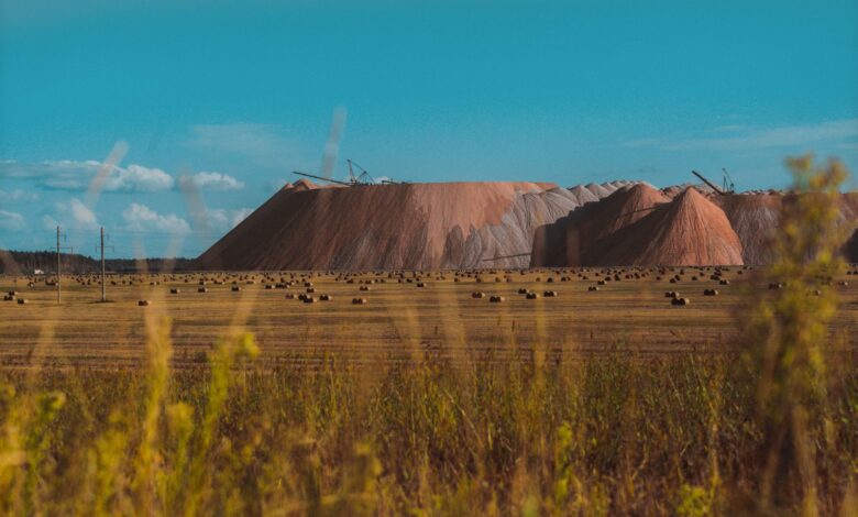 Open-pit bauxite mine with heavy excavation equipment and exposed red ore deposits