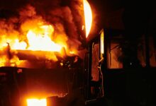 Interior of an industrial zinc smelting facility with molten metal processing equipment