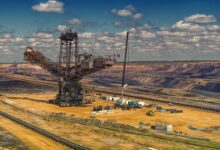 Open pit uranium mine with industrial equipment operating at the extraction site