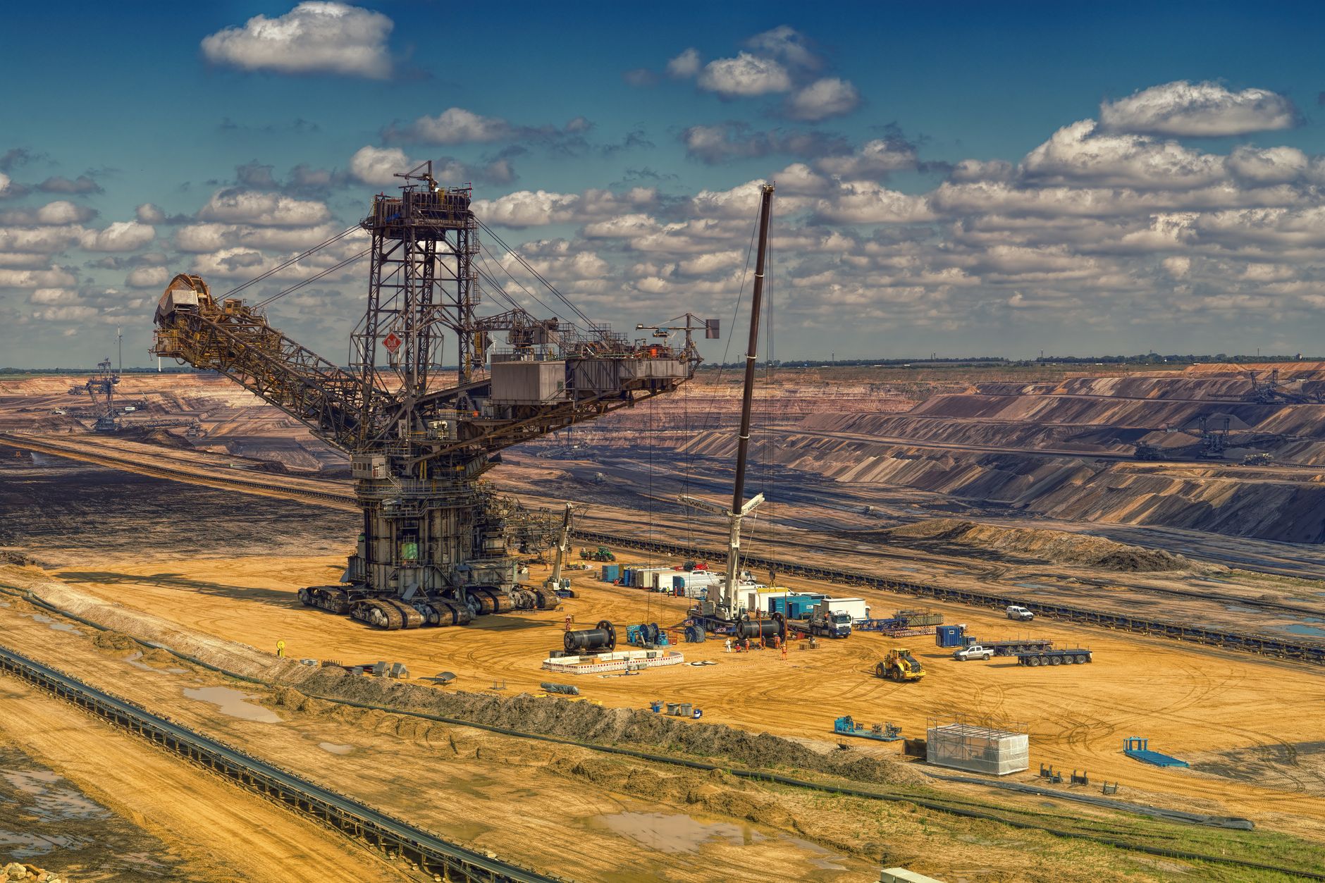 Open pit uranium mine with industrial equipment operating at the extraction site