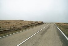 Fresh liquid asphalt being laid on a road surface during construction
