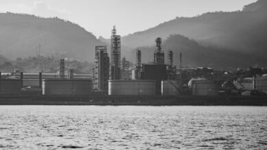 Large oil refinery facility with processing towers and pipelines representing sulfur byproduct production