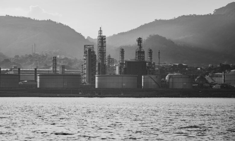Large oil refinery facility with processing towers and pipelines representing sulfur byproduct production