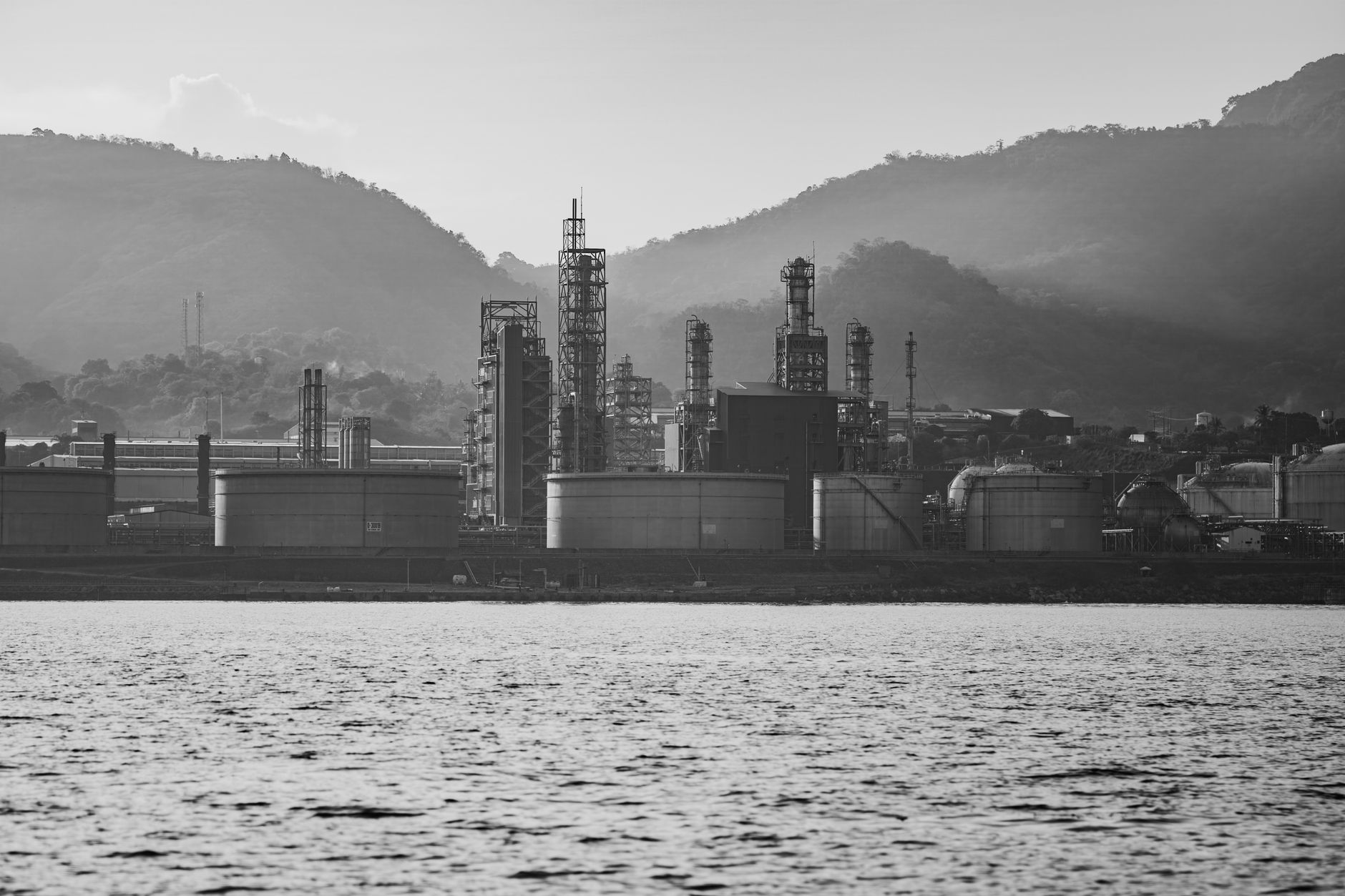 Large oil refinery facility with processing towers and pipelines representing sulfur byproduct production