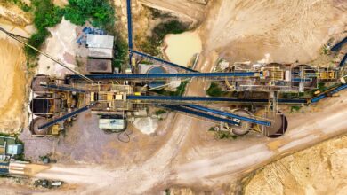 Aerial view of an open-pit rare earth mining operation with heavy equipment