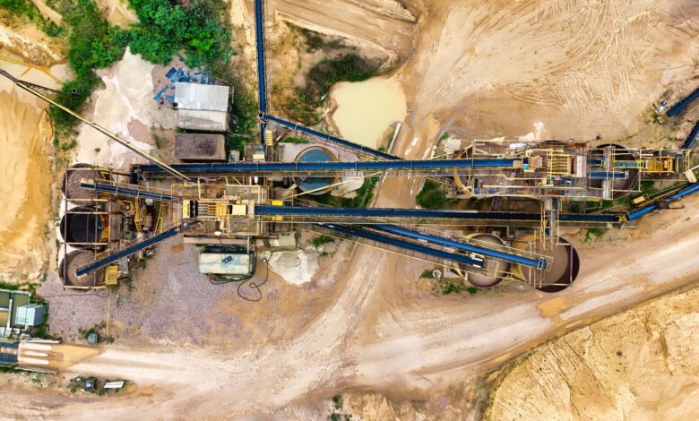 Aerial view of an open-pit rare earth mining operation with heavy equipment