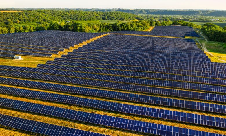 Aerial view of a large utility-scale solar farm on agricultural land