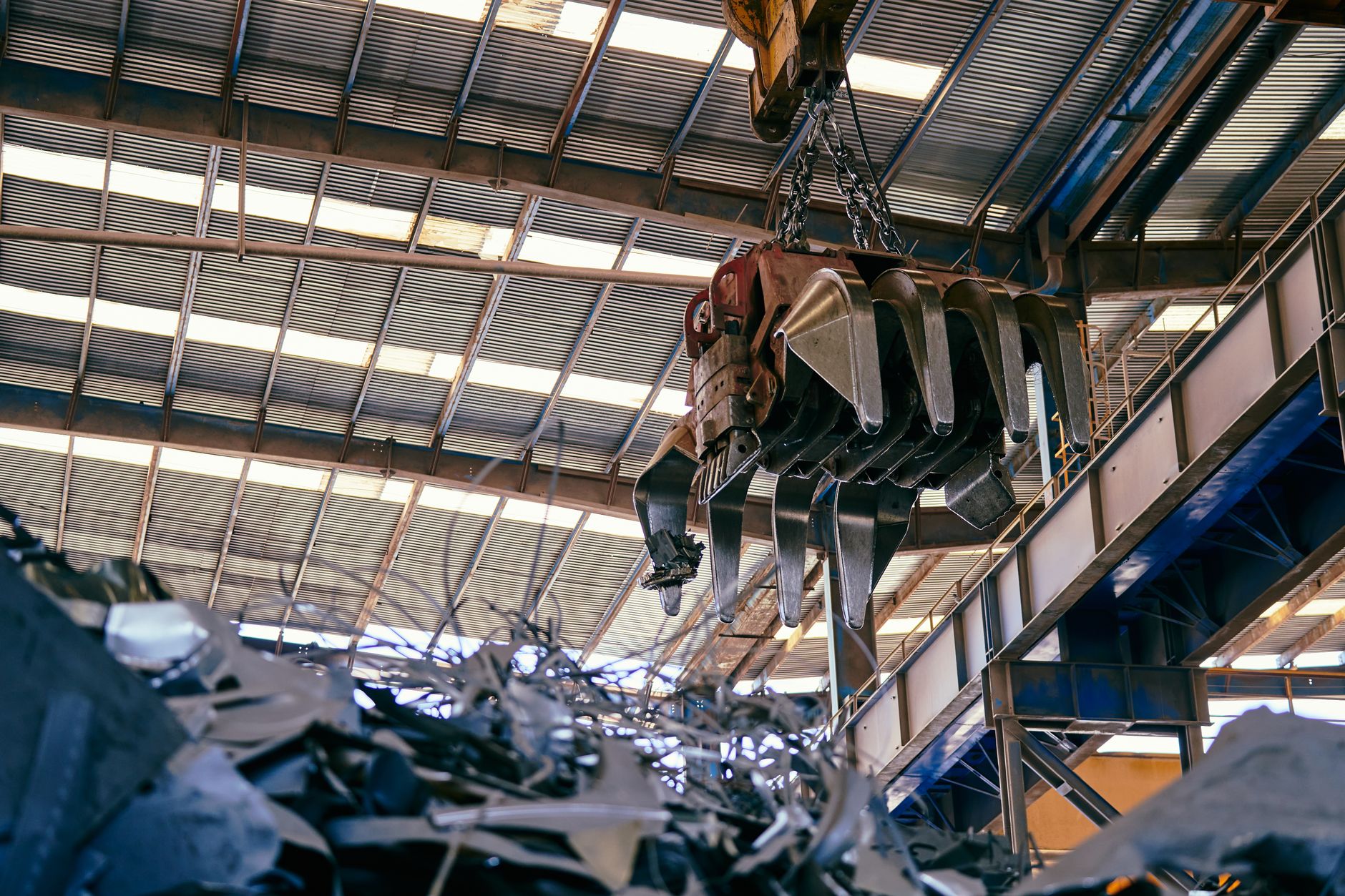 Workers inside a titanium metal processing facility with industrial equipment
