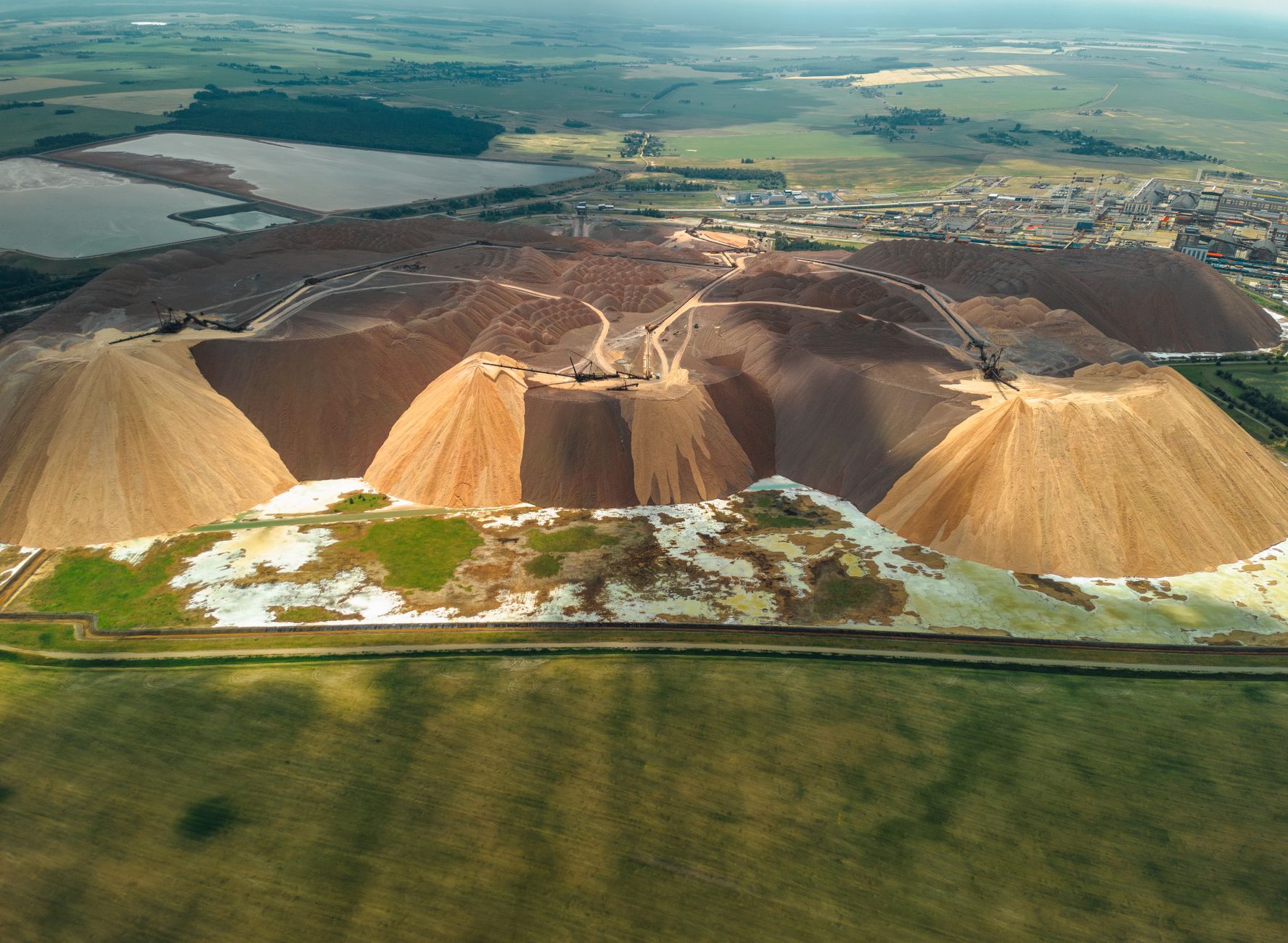 Aerial view of an active potash mine with extraction equipment and mineral deposits