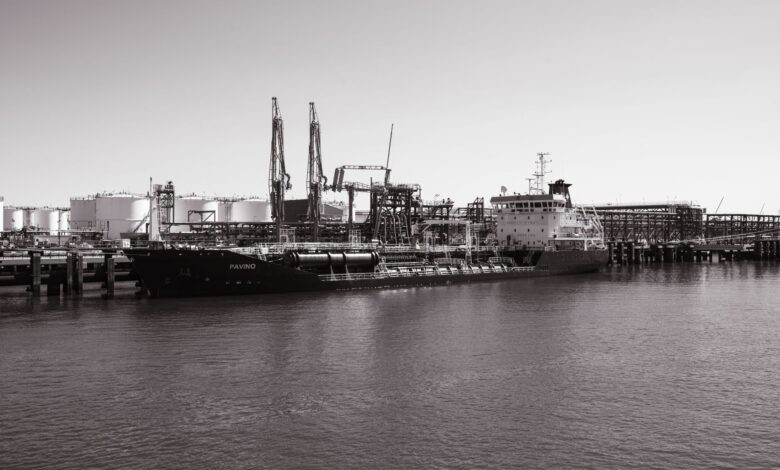 Large industrial oil storage terminal with tanks and port infrastructure