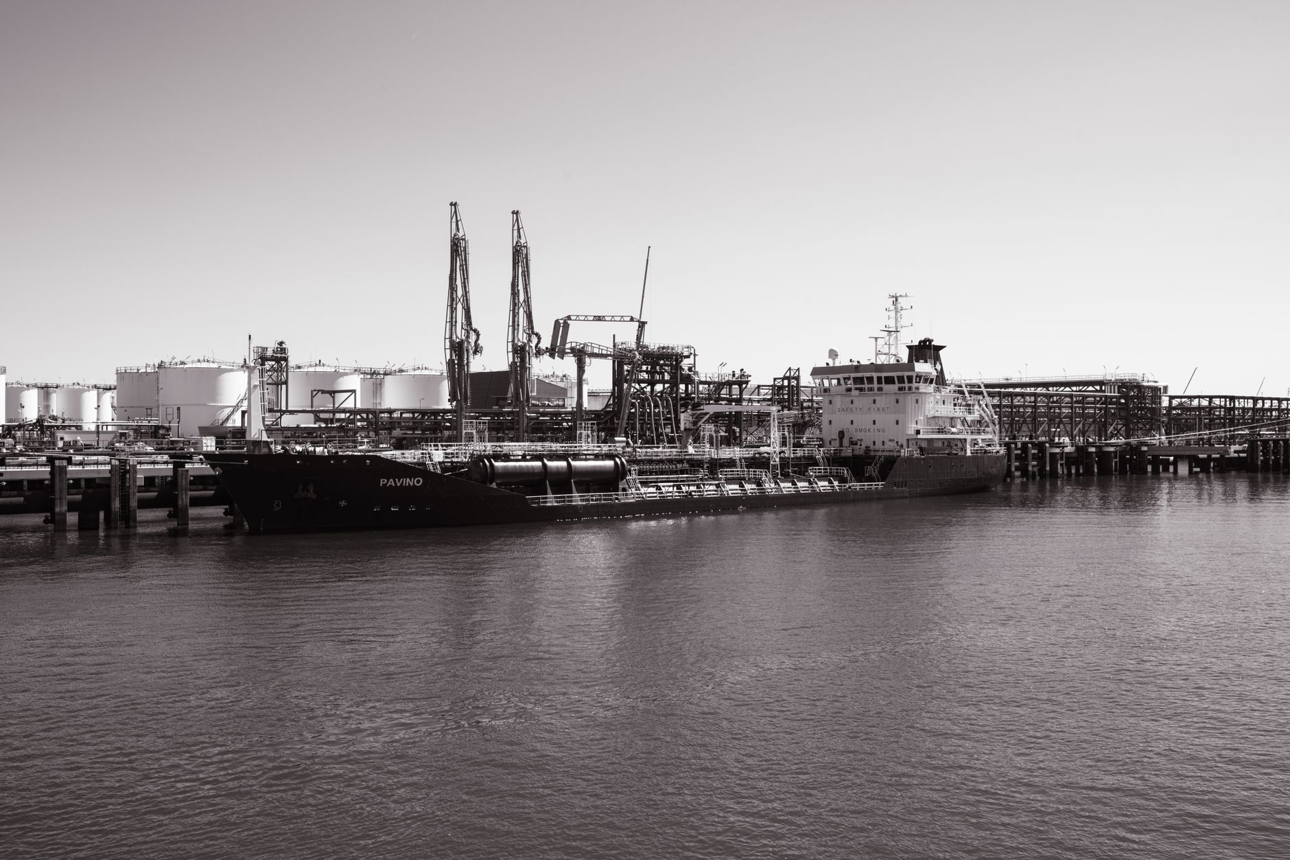 Large industrial oil storage terminal with tanks and port infrastructure