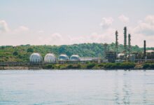Large industrial petrochemical facility with storage tanks and processing towers