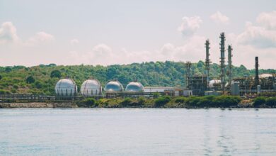 Large industrial petrochemical facility with storage tanks and processing towers
