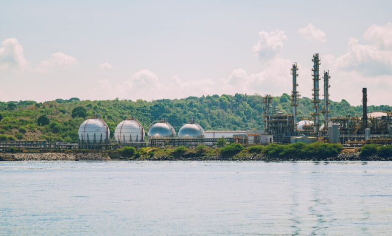 Large industrial petrochemical facility with storage tanks and processing towers