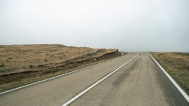 Fresh liquid asphalt being laid on a road surface during construction