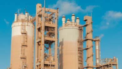 Large industrial chemical plant with pipes and processing towers at dusk