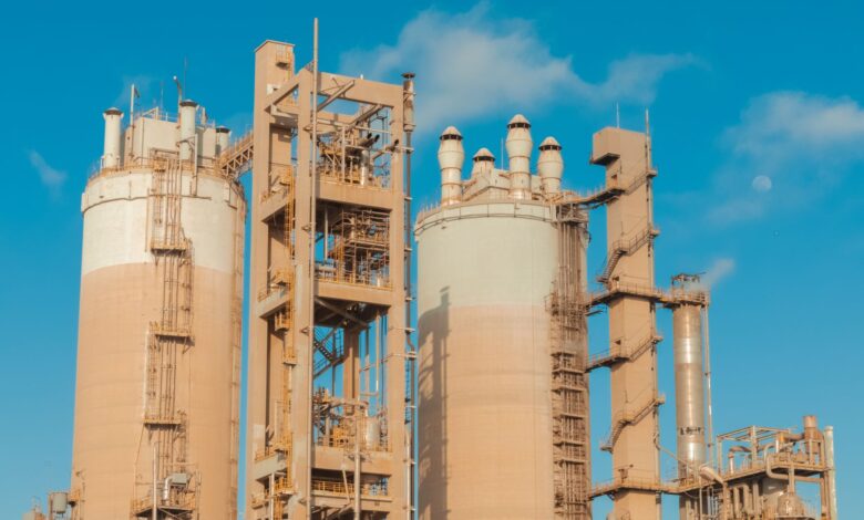 Large industrial chemical plant with pipes and processing towers at dusk