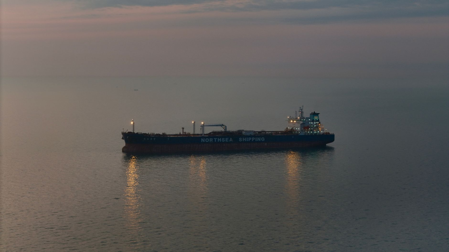 Large crude oil tanker vessel sailing across open ocean waters