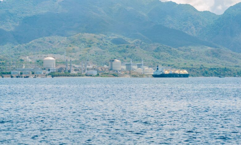 Large LNG regasification terminal with storage tanks at a coastal port