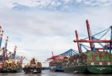 Large cargo vessel docked at an industrial port terminal