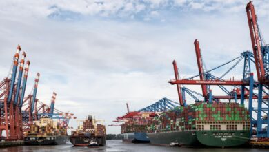 Large cargo vessel docked at an industrial port terminal