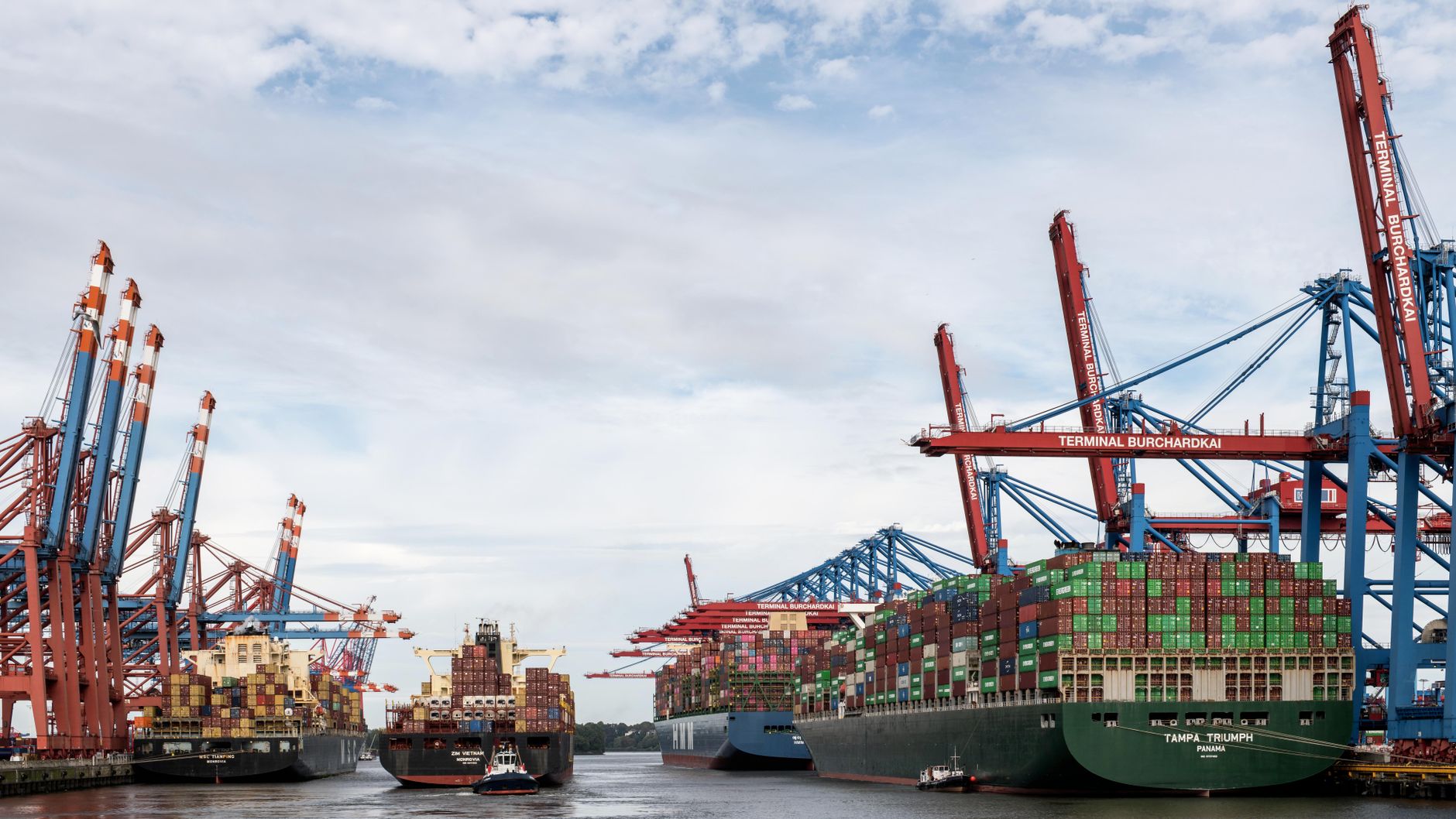Large cargo vessel docked at an industrial port terminal