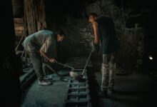 Interior of an industrial metal smelting facility with molten material being processed