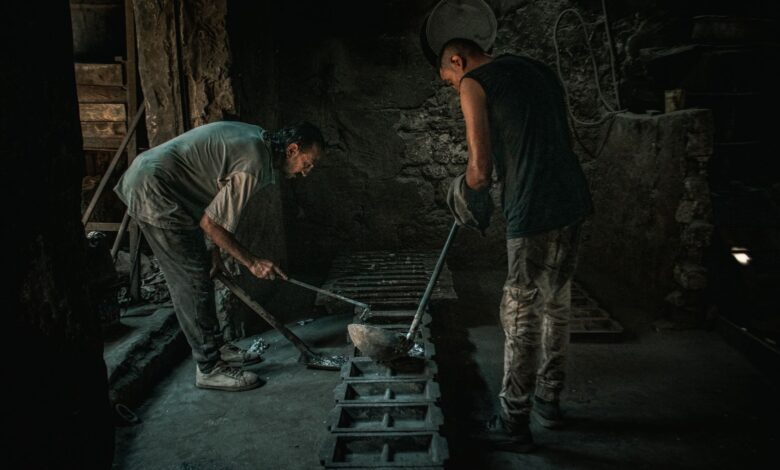 Interior of an industrial metal smelting facility with molten material being processed