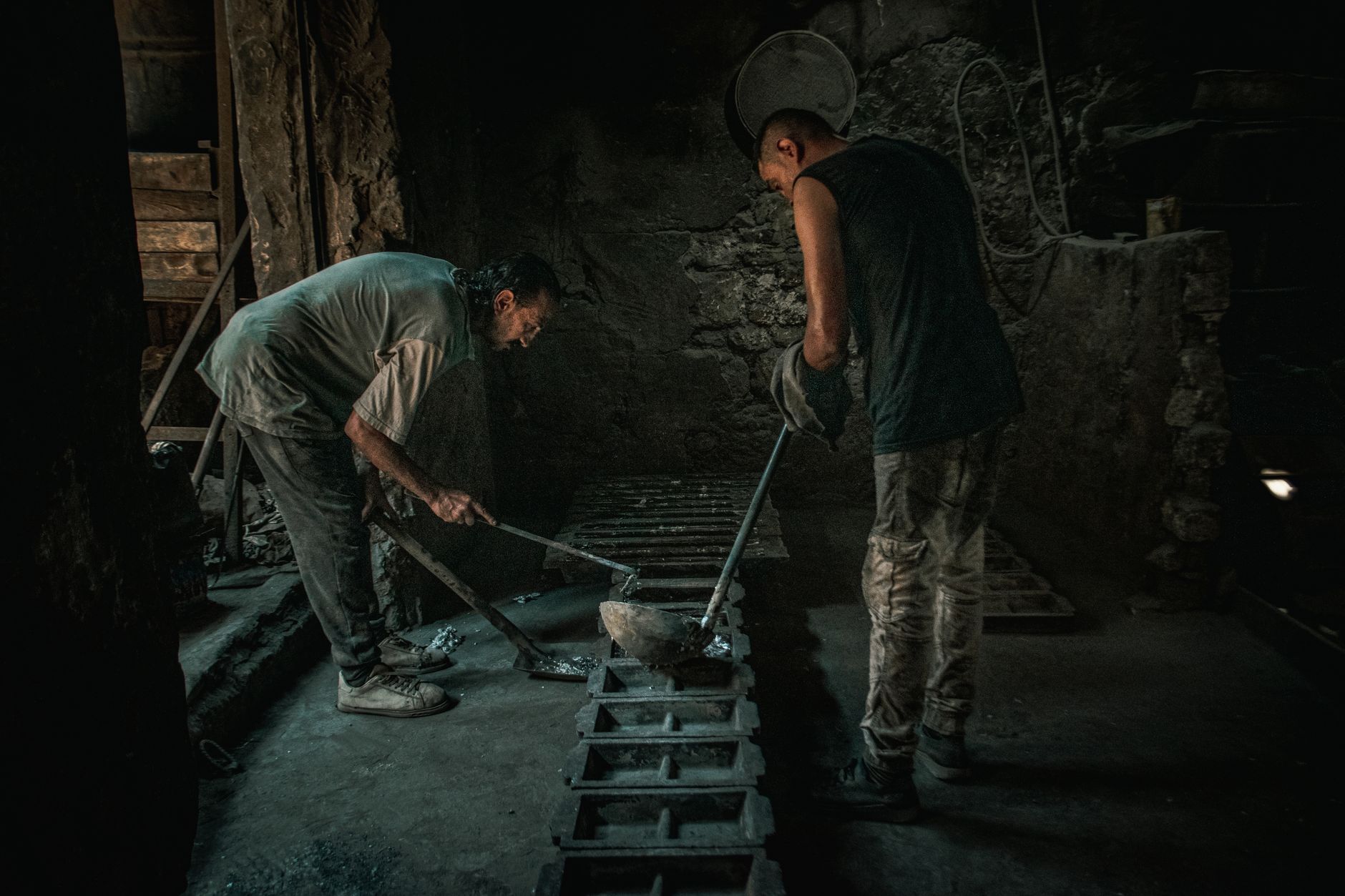 Interior of an industrial metal smelting facility with molten material being processed